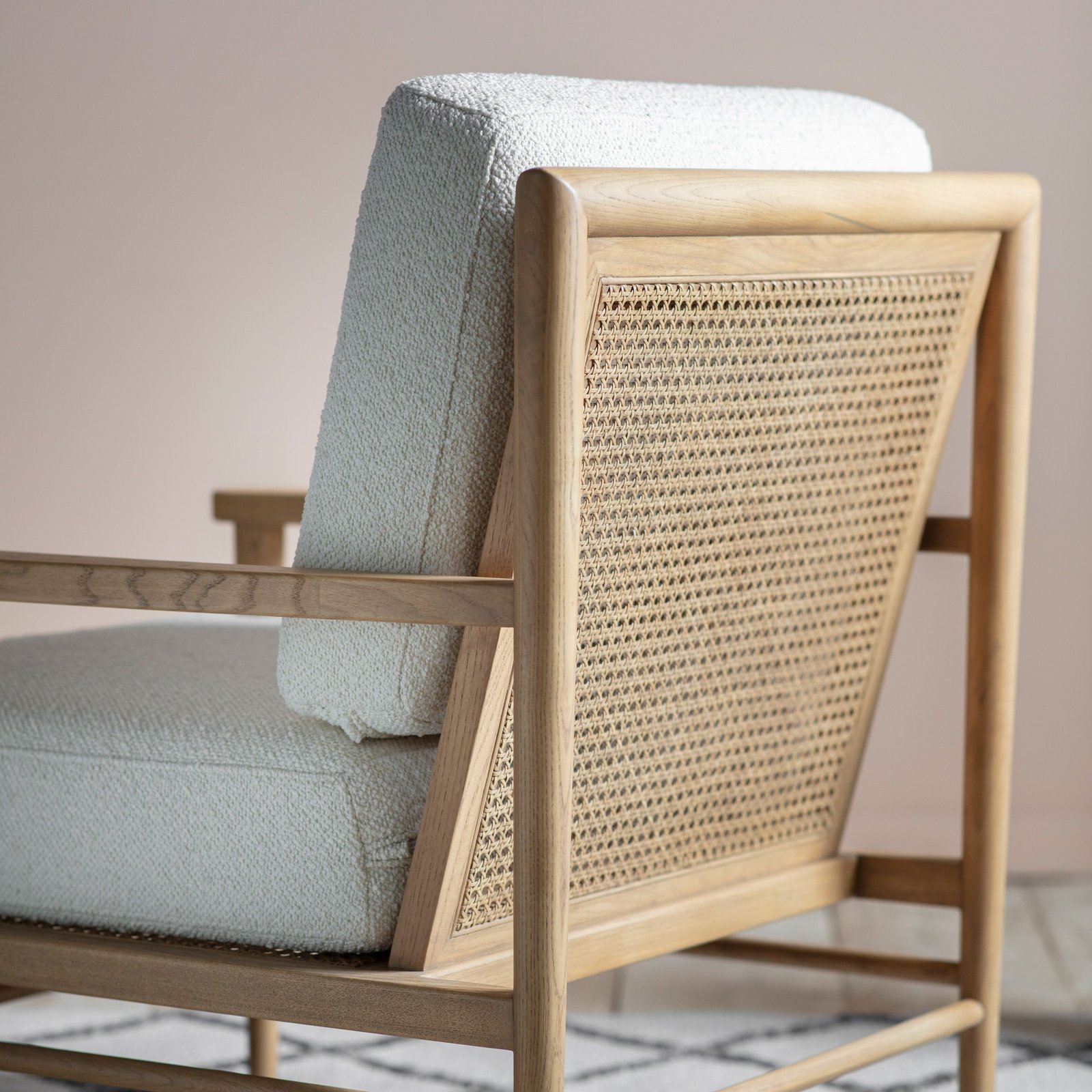 cane and boucle chair