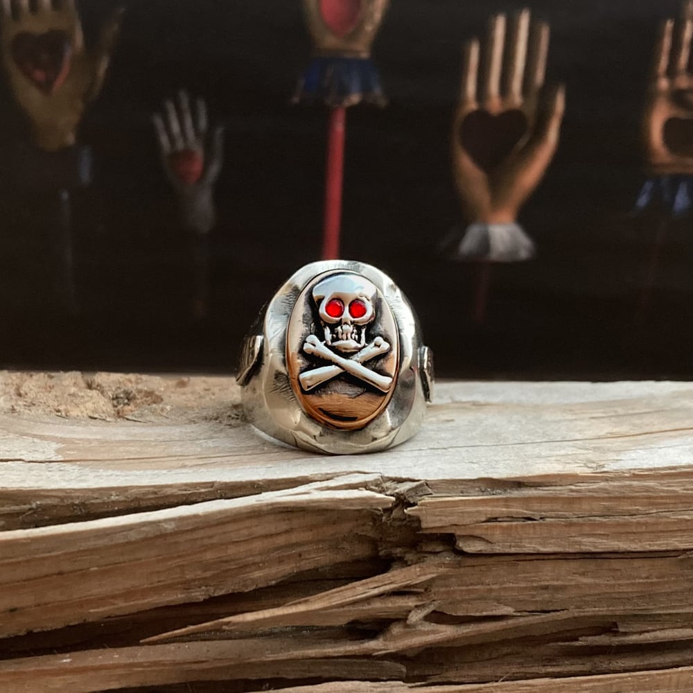 OVAL RUBY EYED SKULL CROSSBONES RING