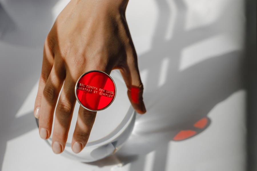 Image of "The Sun illuminates.." silver ring with red plexiglass · SOL CUNCTA SUA ·
