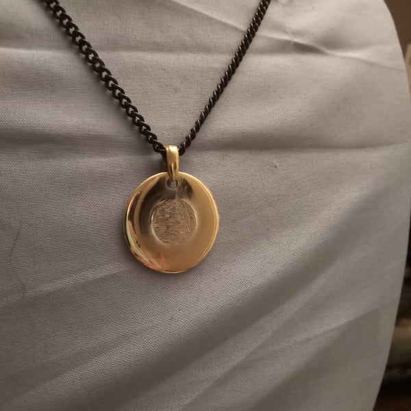 Image of Golden pendant with black chain