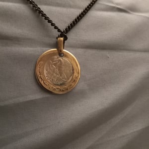 Image of Golden pendant with black chain