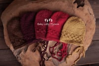 Image 1 of Newborn openwork  bonnet warm colours