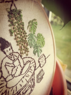 Embroidery hoop girl with her plants 