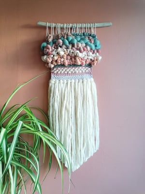 Art yarn woven wallhanging in peaches, pinks and laurel 