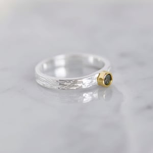 Image of Bluish Green Sapphire round cut 18k gold plated x silver flat band ring