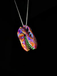 Image 1 of Amber purple T-Rex skull pendant with illuminati (UV) teeth. 