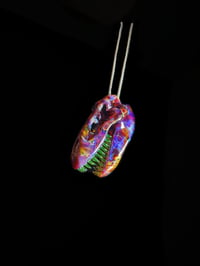 Image 2 of Amber purple T-Rex skull pendant with illuminati (UV) teeth. 