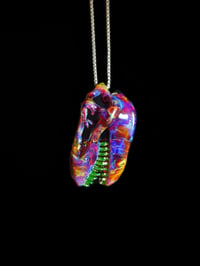 Image 3 of Amber purple T-Rex skull pendant with illuminati (UV) teeth. 