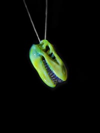 Image 1 of Green energy T-Rex skull pendant with mirage teeth. 