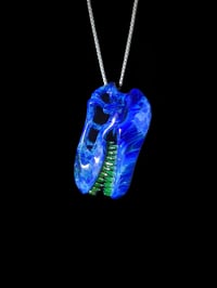 Image 3 of Irrid T-Rex skull pendant with illuminati (UV) teeth.