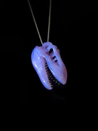 Image 1 of Lucid T-Rex skull pendant with galaxy teeth. 