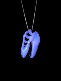 Image 4 of Lucid T-Rex skull pendant with galaxy teeth. 