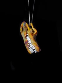 Image 1 of Mixed color alligator skull pendant.