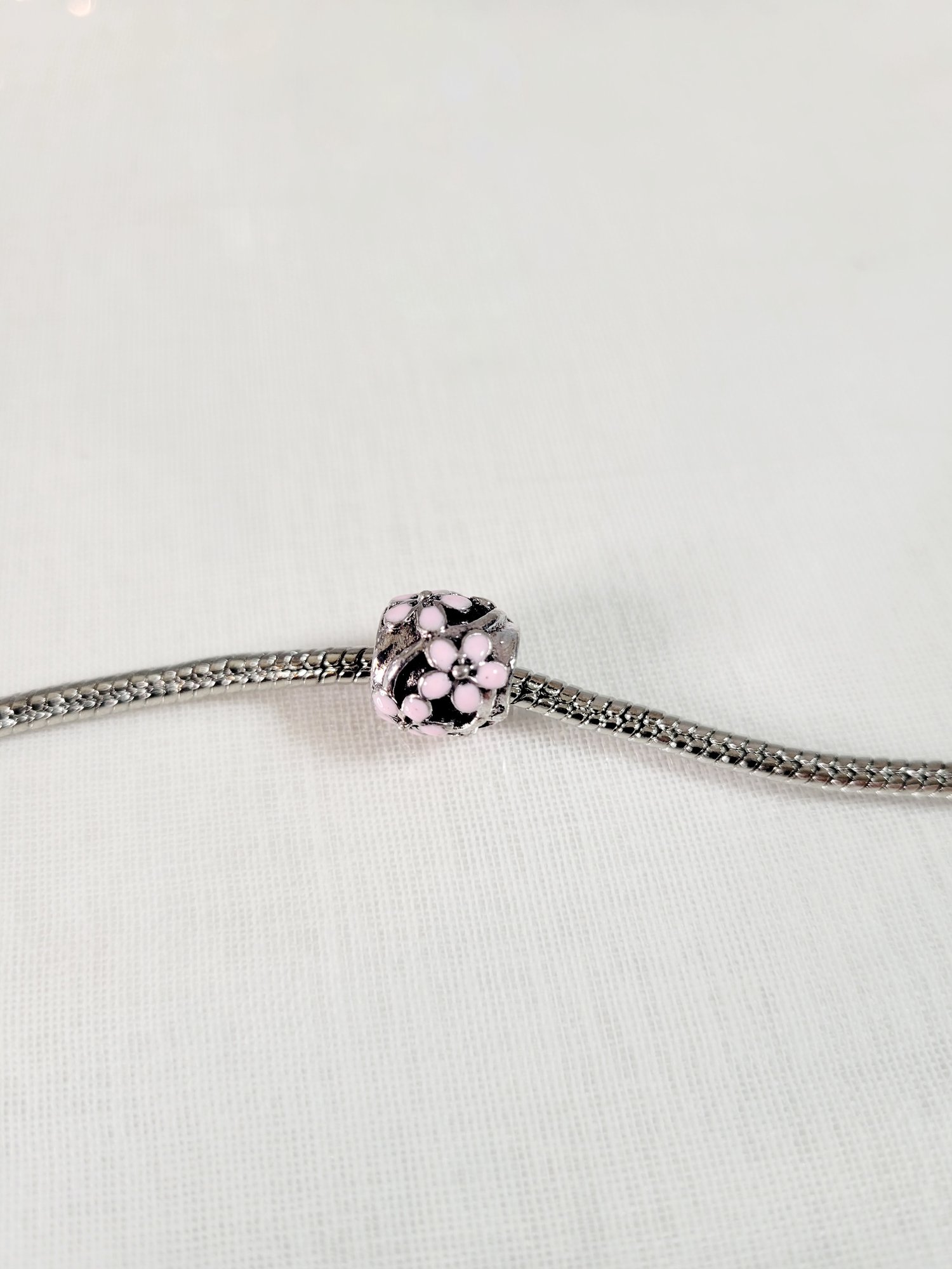 Image of Round Hollow Pink Flowers Charm