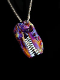 Image 1 of Double amber purple T-Rex skull pendant.