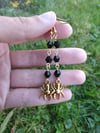 Gold spider earrings with black faceted beads