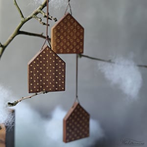 Image of Christmas tree ornaments, elegant wooden houses decorations with gold color patterns, set of 8