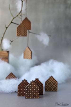 Image of Christmas tree ornaments, elegant wooden houses decorations with gold color patterns, set of 8