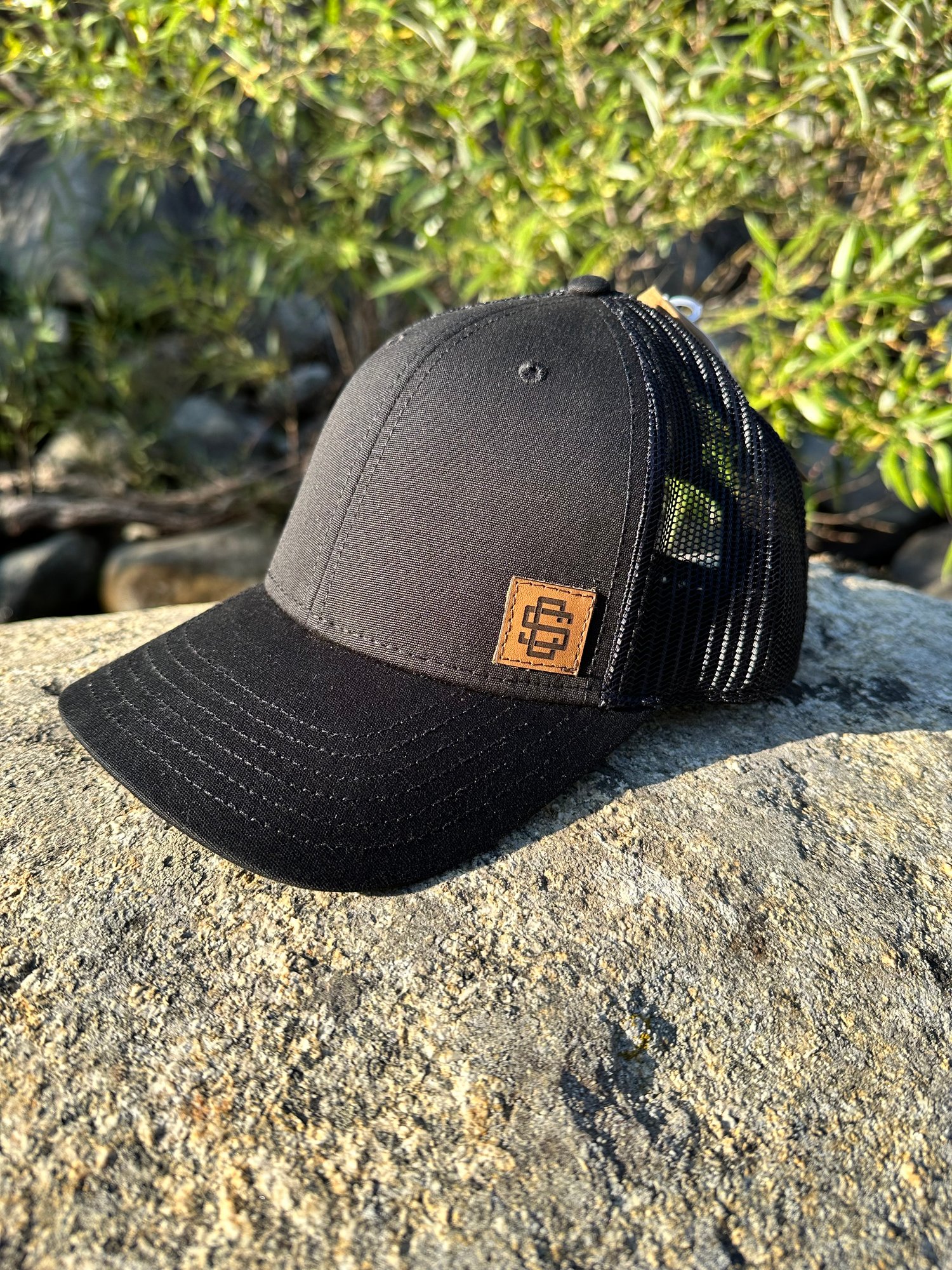 Black Snapback Trucker Hat with Brown Patch 