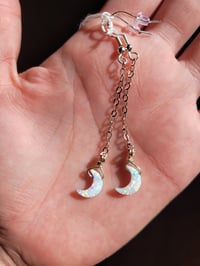 Image 1 of Opal crescent moon earrings.