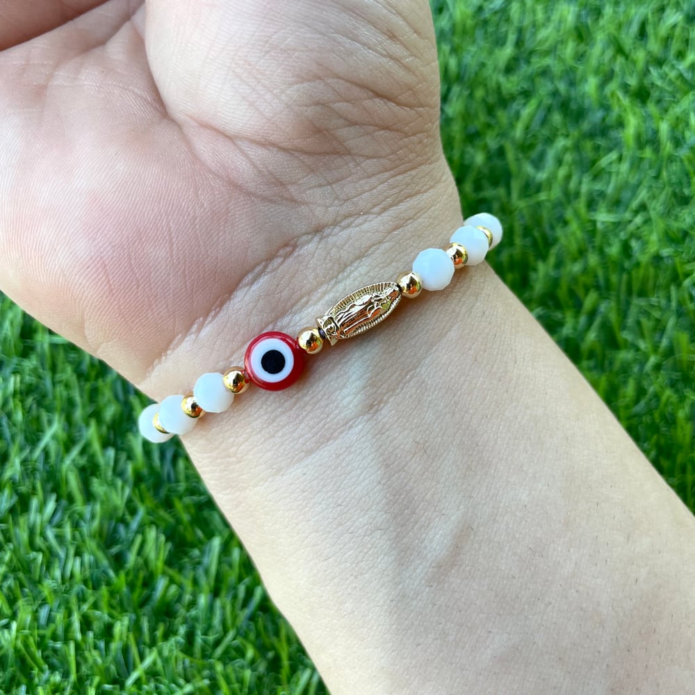 Virgencita with red evil eye bracelet