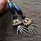 Image of Purple And Copper Skeleton Embrace Crystal Beaded Earrings