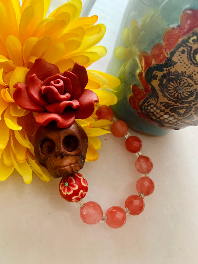 Image of Day of the dead wood carved skull with cherry quartz