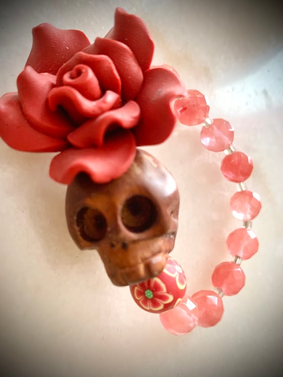 Image of Day of the dead wood carved skull with cherry quartz