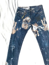 Image of hands on denim jeans 