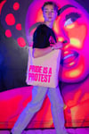 PRIDE IS A PROTEST Tote bag (White, pink print and navy handle)
