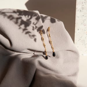 Image of Gold and black long earrings