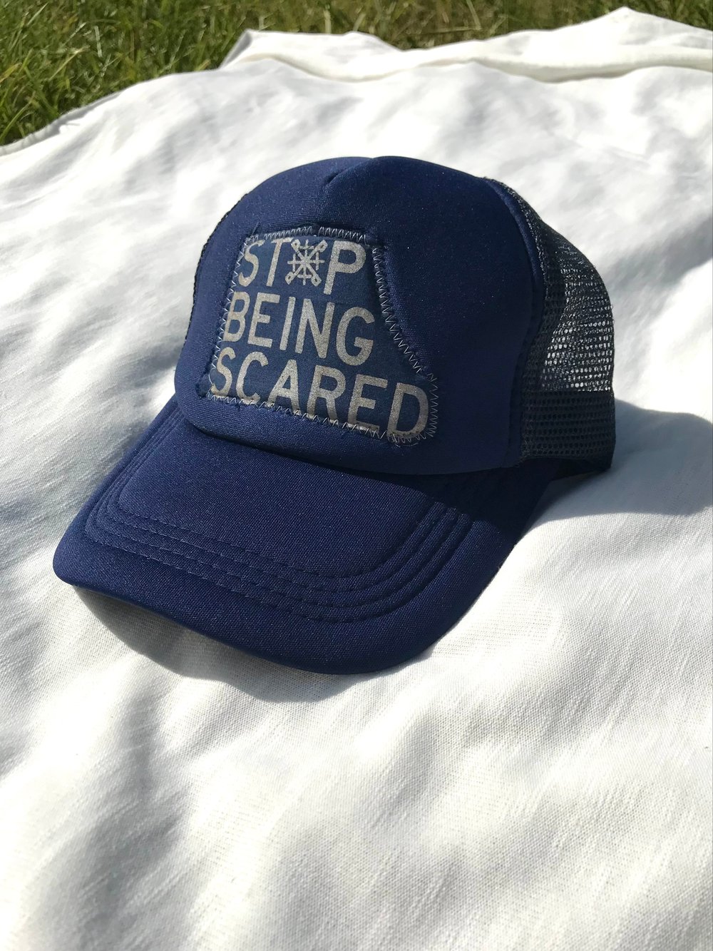 the stop being scared trucker cap in navy blue