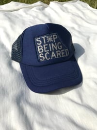 Image of the stop being scared trucker cap in navy blue