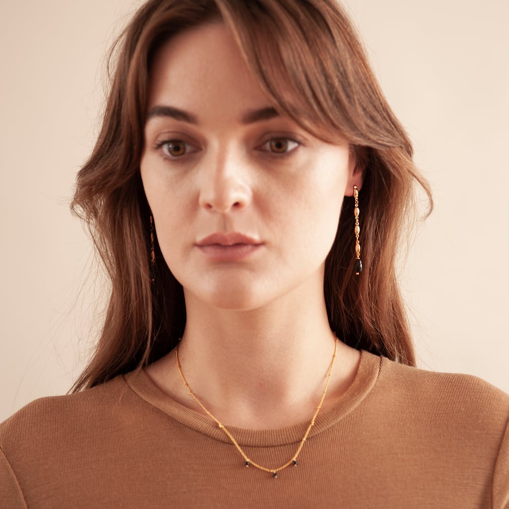 Image of Gold and black long earrings