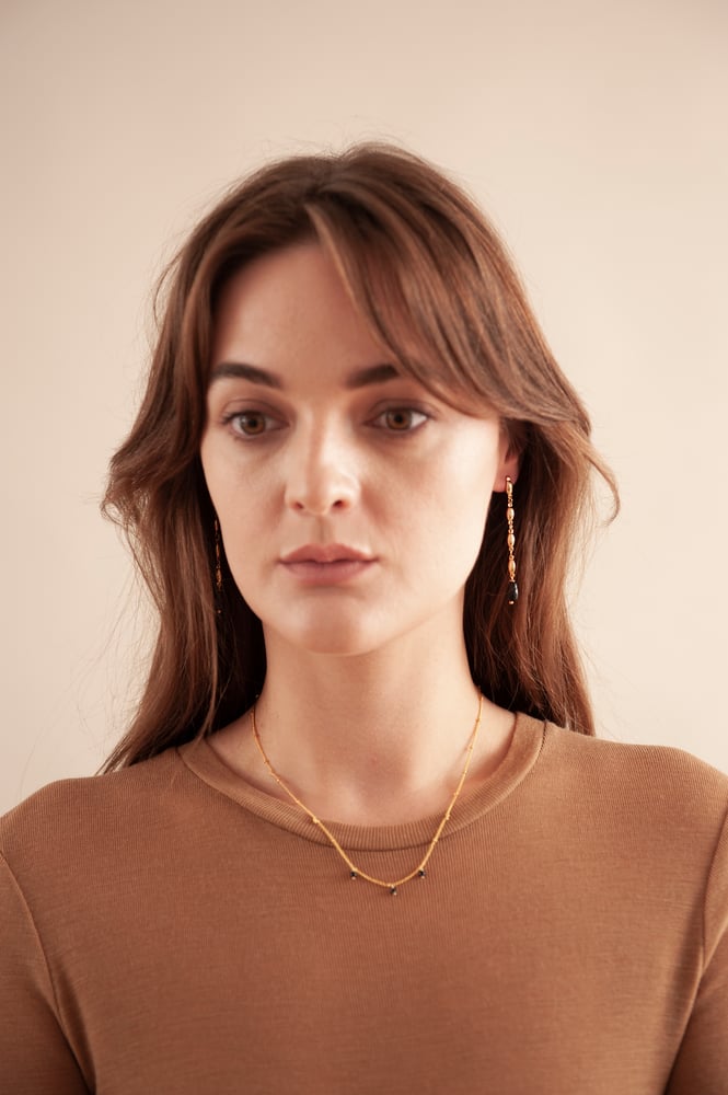 Image of Gold and black long earrings