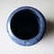 Image of blue on black curved vase