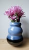 Image of blue on black curved vase