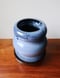 Image of blue on black curved vase