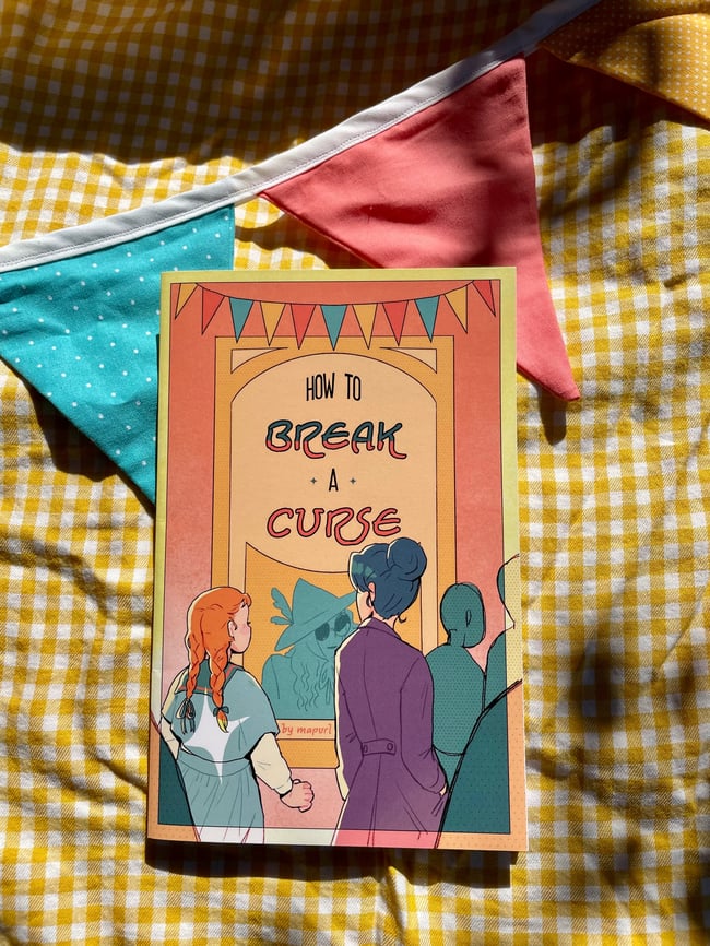 The cover of the comic "How to Break a Curse" by mapurl. Two women are gazing at a poster, which has the title of the comic, implying a connection. A figure with dark glasses and a fancy hat occupies the poster. The women gazing at the poster have their backs to the viewer, but they are both visibly intrigued by its contents