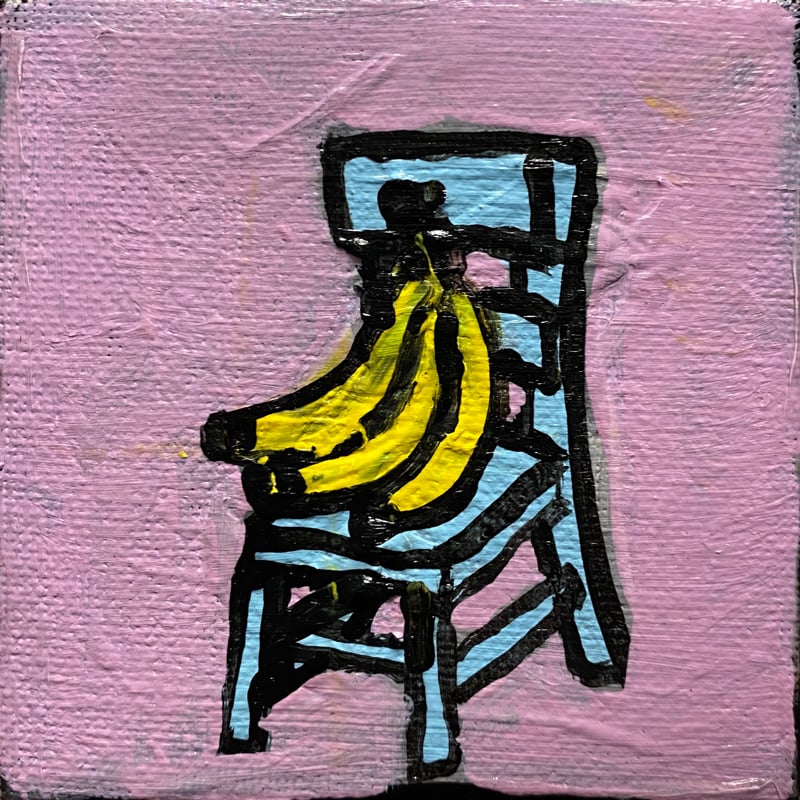 Image of enormous bunch of bananas on a tiny blue chair