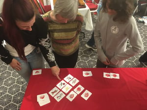 Image of A game about quickly grabbing cards and judging them against three descriptions. 