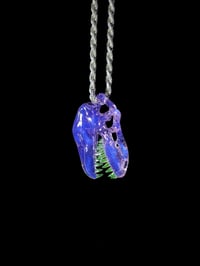 Image 2 of Rose quarts T-Rex skull pendant with illuminati teeth. 