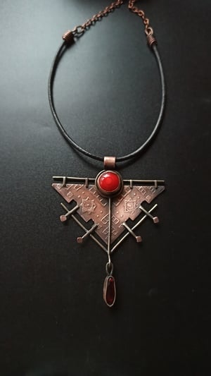 Copper ethnic pendant with red accents 