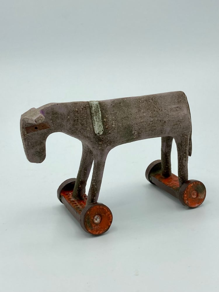 Image of Small Donkey on Orange Wheels