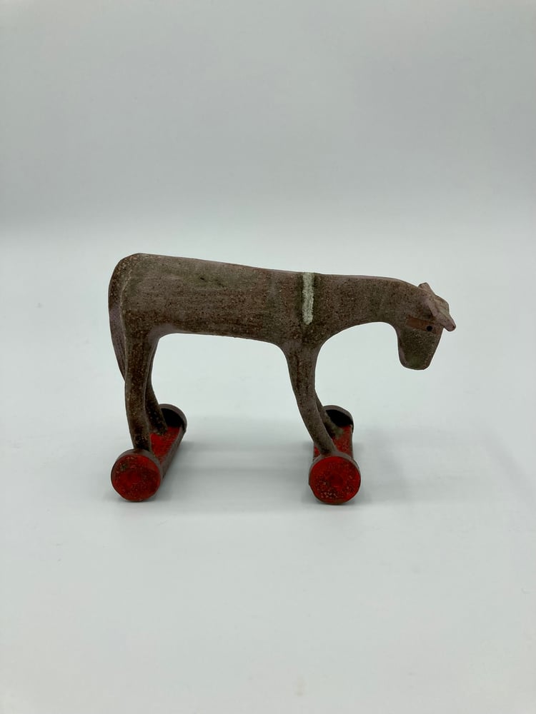Image of Small Donkey on Red Wheels