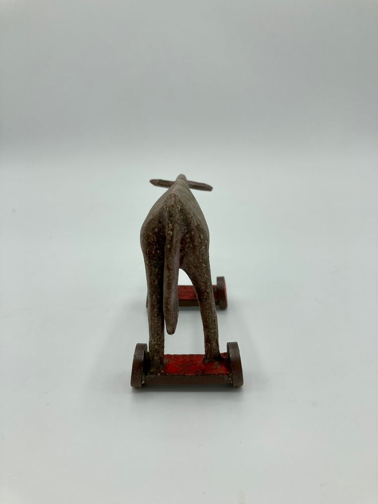 Image of Small Donkey on Red Wheels