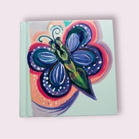 Light blue sketchbook with butterfly