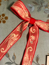 Image 1 of Red long tail bow with vintage dragon lace. 