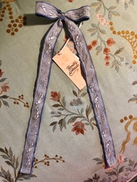 Image 2 of Blue long tail bow with vintage bird lace. 