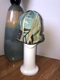 Image 4 of H.O.D. Bucket Hat Chocolate Butter Leather Crown W/Reversible Leaf Print Cotton Fabric Side